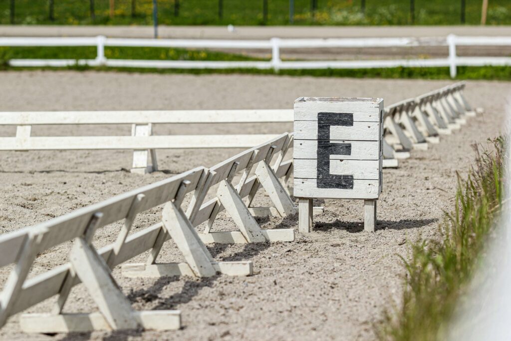 Riding arena with the E marked on a block in the ground